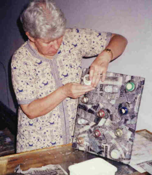 Janet making a bottle lid toy